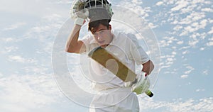 Low angle view cricket player taking off his helmet