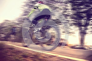 Low angle view of cyclist riding mountain bike, Vintage style