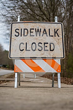 Low Angle View of Dirty Sidewalk Closed Sign