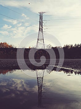 Low angle view of electricity pylon against sky during sunset