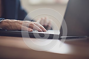 Low angle view of female hand using laptop computer