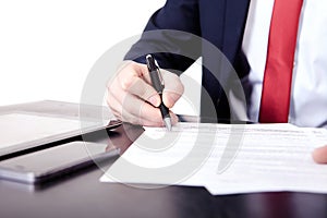 Low angle view of the fingers of a man writing on a document with a fountain pen conceptual of communication