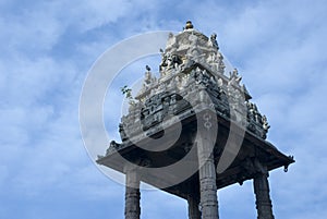 Low angle view of gopuram against cloudy sky photo