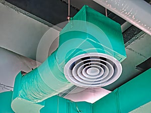Low Angle View of Green Insulated Air Conditioning Duct with Round Grille Diffuser