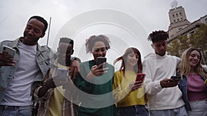 Low angle view of a group of young teenagers using cell phones. Concept of technology, connection.