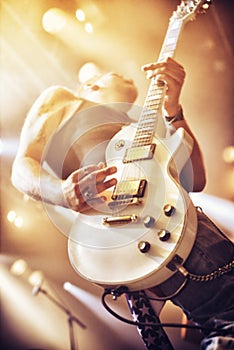 Low angle view of a guitarist on stage at a gig. This concert was created for the sole purpose of this photo shoot