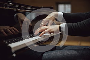 Low angle view of hands of a pianist playing pian