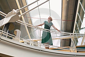 Happy Businesswoman standing in the corridor at office