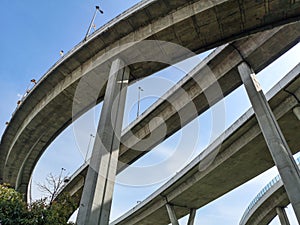 Low angle view of huge and stately bridge with strong pillar with blue sky in the background, urban and futuristic concept