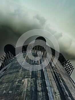 Low angle view of the imposing Flak tower under a cloudy sky