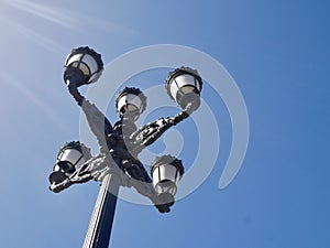 Low angle view of lamp at Plaza de Zocodover, against blue sky. photo