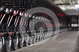 Low angle view of line trolley shopping cart in the car park area.