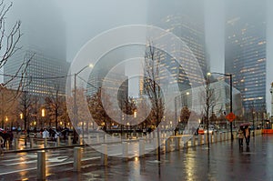 Low Angle View of Lower Manhattan Skyscrapers on a Foggy Night. Buildings Fading into the Fog