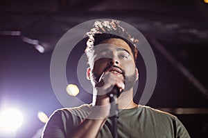 Low angle view of male singer performing at nightclub