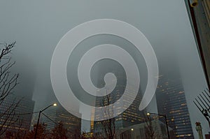 Low Angle View of Manhattan Freedom Tower and other Skyscrapers on a Foggy Night in New York City. Buildings Fading into the Fog