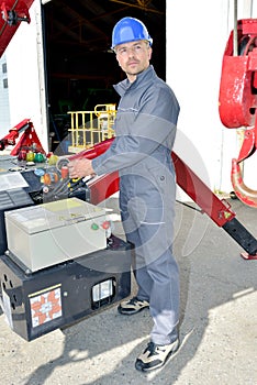 Low angle view manual worker operating crane