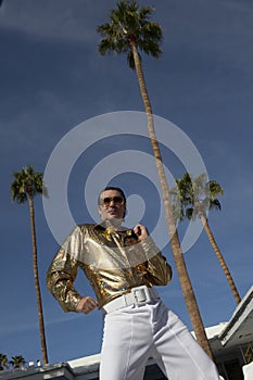 Low angle view of middle-aged man impersonating Elvis Presley photo