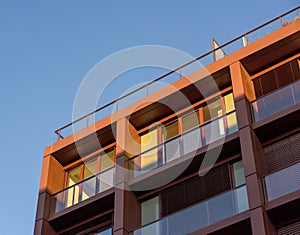 Low angle view of modern apartment building with clear blue sky in the