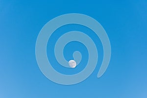 Low angle view of the moon against blue sky.