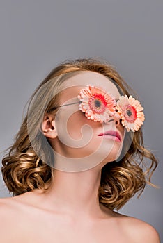 low angle view of naked girl wearing glasses with flowers