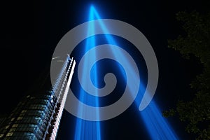 Low angle view of the NYC Skyline and the 9 11 memorial under neon blue lights at night