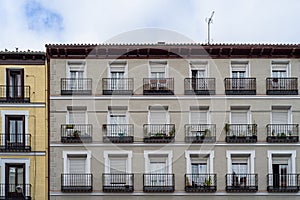 Low angle view of old residential buildings in Lavapies quarter in central Madrid photo