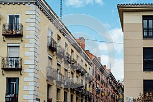 Low angle view of old residential buildings in Lavapies quarter in central Madrid photo