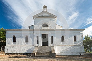 Low-angle view of an old white building with stairs leading to the entrance