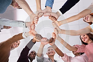 Low Angle View Of People Making Circle With Their Hands