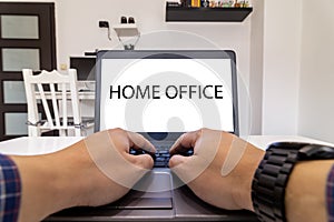 Low angle view of a person typing on a laptop. Stay home concept