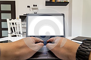 Low angle view of a person working on a laptop from home