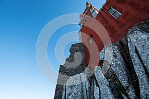 Low angle view of the red castle on rocks under a blue sky in Sintra-Cascais in Portugal