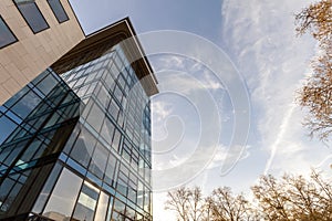 Low angle view of reflection of blue sky in glass wall of modern