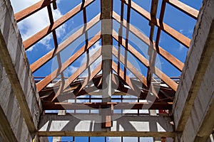 Low angle view of roof trusses and framing wooden of new house c