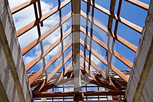 Low angle view of roof trusses and framing wooden of new house c