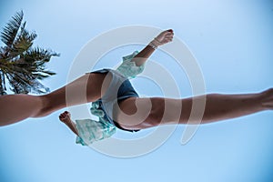 Woman jumping or crossing step over at beach