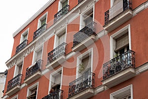Low angle view of small balconies residential building facade in Madrid