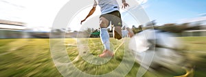 Low angle view of soccer player kicking ball.