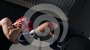 Low angle view of sportsmen fighting at boxing ring