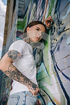 low angle view of stylish tattooed girl