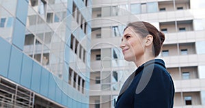 Low angle view of successful business lady standing outside office building