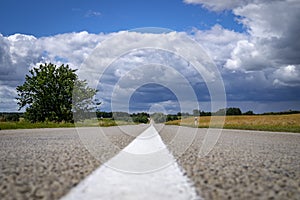 Low angle view of a tarred road receding