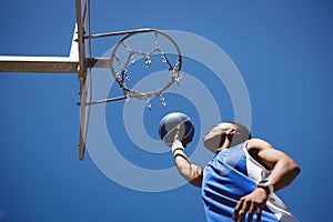 Low angle view of teenage boy playing basketball