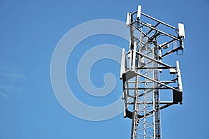 Telecommunications tower against a blue sky.