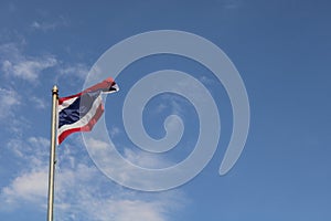 Low angle view of thailand flag against blue sky.