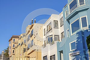 Low angle view of three-storey houses with attached garage in San Francisco, California