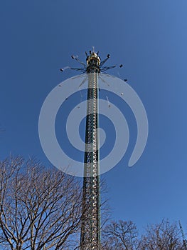 Low angle view of turning drop tower in famous amusement park Wurstelprater in Vienna, capital of Austria.