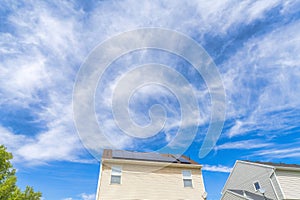 Low angle view of two houses with wood vinyl sidings and solar panels on roof at Utah valley