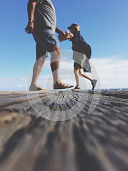 Low angle view - two people walking on walkway