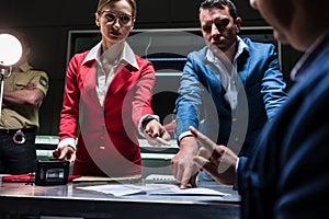 Two persuasive investigators trying to obtain a confession from photo